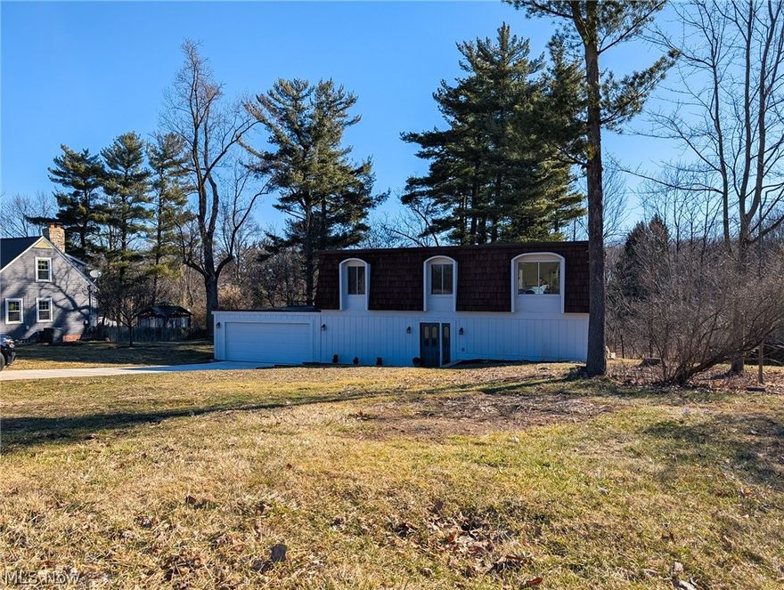 No detail has been missed in this 4 bedroom, 3 bathroom COMPLETELY RENOVATED AND UPDATED Home sitting on a picturesque lot in Brecksville. Close to parks and schools and minutes from I77. This home was taken down to the studs and rebuilt. High style design and high quality construction will make you proud to call this home and give you years of worry free home ownership. Multiple areas of family hangout and entertaining to choose from. Custom high end kitchen with all new soft close cupboards, stylish black granite and top of the line LG appliances. A beautiful large center island perfect for family meals and entertaining while still being in the kitchen. Welcome your guests through the front door into the foyer with custom hand painted tile floor. A large family room with access to the 3 tier deck overlooking the backyard . A 1st floor master bedroom with shared access attached bathroom anchor this floor. Upstairs you will find the beautiful kitchen, dining room and sitting room , also with access to the deck. 3 large bedrooms and full bathroom and additional 1/2 bathroom off of the sitting room, finish off the top floor. A beautiful mud room right off the garage. 1st floor laundry. New roof, new HVAC, new plumbing, updated/new electric, updated/new windows (with transferrable warranty) new lighting, new plumbing, new bathrooms, flooring, and paint. All new concrete driveway and sidewalk with proper updated draining. Cleaned, painted and sealed cedar siding. Nothing left to do but move in.