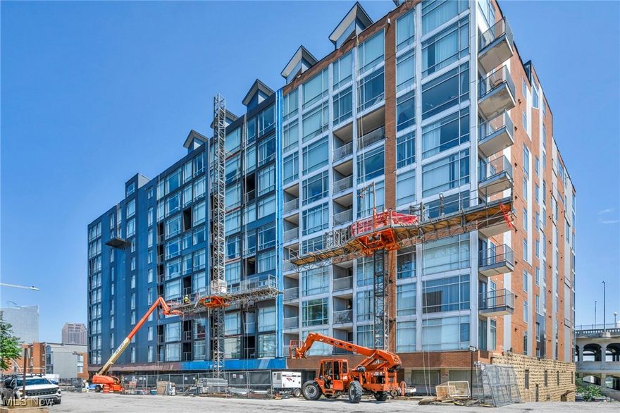 Experience contemporary city living in this light-filled 2-bedroom, 2-bath condo nestled on Cleveland’s vibrant West Bank of the Flats. Floor-to-ceiling windows frame captivating views of the city skyline, and iconic bridges.  Newer flooring runs throughout the open-concept living and dining space, bathed in natural light and ideal for relaxing or entertaining. The updated, sleek modern kitchen impresses with a tile back splash, ample cabinetry, and a large island offering additional seating and functionality for gatherings or casual meals. Double doors lead into the second bedroom, making it a perfect home office or flexible bonus space with private balcony access and expansive windows that blend indoor comfort with outdoor connection. The primary suite offers a serene retreat with an en suite bath. Residents enjoy premium building amenities, including: Concierge service, on-site fitness center, stylish resident lounge, steps from acclaimed restaurants, bars, and cultural hot spots, and with easy highway and public transit access, this location puts the best of Cleveland at your doorstep. Exterior renovations are underway! *Assigned parking space may be included for additional cost.