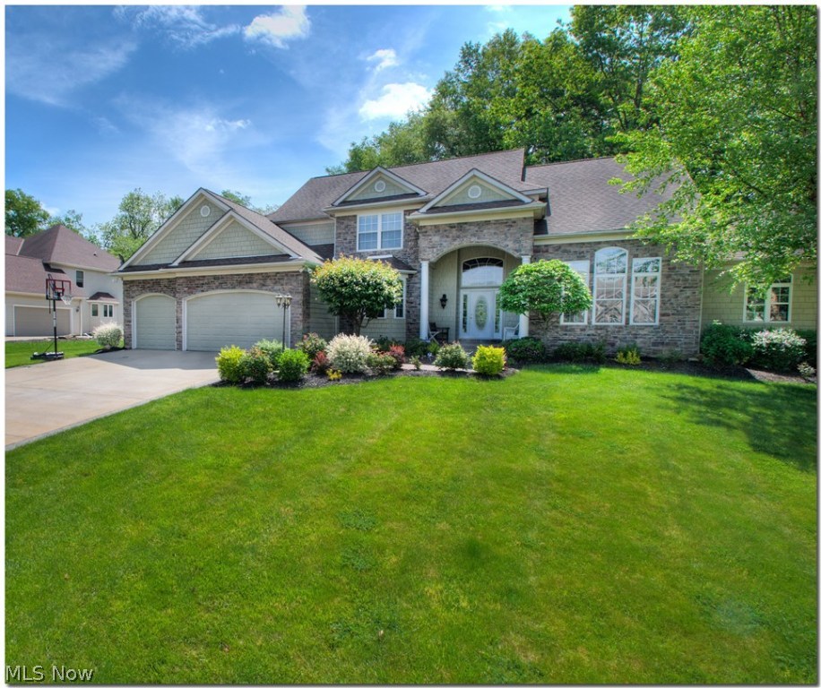 Absolutely beautiful, immaculate home in desirable Ashford Glen. This custom home is move-in ready. Fabulous for entertaining with its open floor plan that flows from the large foyer into the dining room, great room and then into the gourmet kitchen which features custom cherry cabinetry, granite counters, stainless steel appliances, walk in pantry, gleaming hardwood floors. Spectacular first floor master bedroom with glamour bath and large walk-in closet. Second floor offers three large bedrooms with plenty of closet space, one full bath and one half bath. Finished walkout lower level includes bedroom with walk in closet and full bath, family room, private workshop, and storage area. Serene,wooded homesite with gorgeous landscaping, backyard firepit, deck, screened in porch and a 3 car garage makes this one a home you don't want to miss!