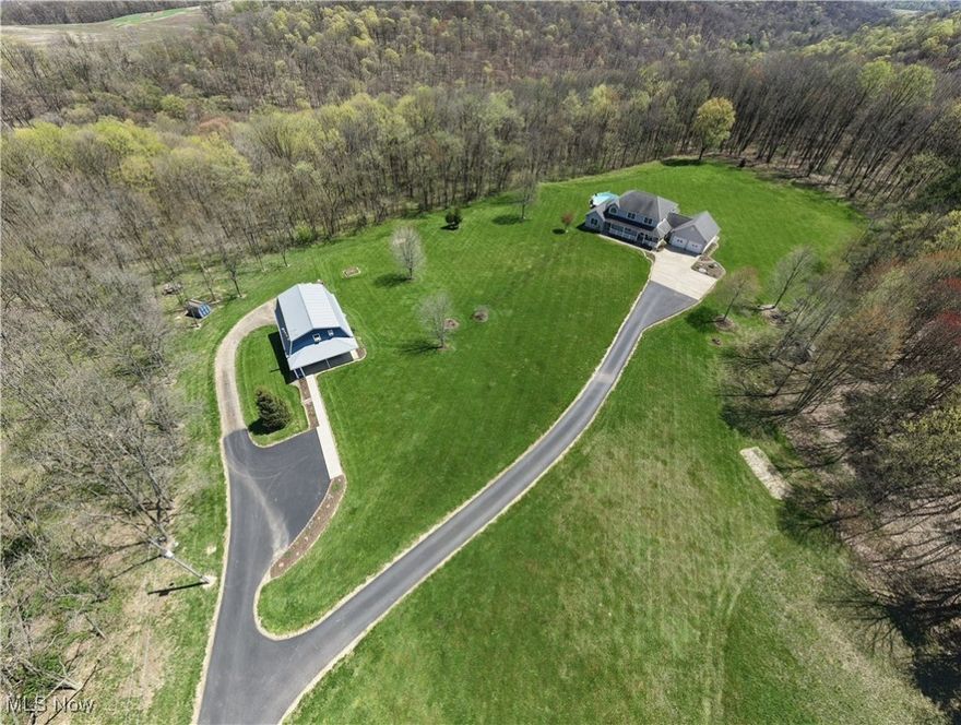 Holmes County-Unique Property! Custom Large Home with Acreage, Pool, Finished Basement, and Second Home/Rental Opportunity! Nestled on a sprawling 16 acres (1/3 open, 2/3 wooded), this exceptional custom-built home offers ultimate privacy, luxury, and versatility. Ideal for those seeking a secluded residence or peaceful retreat with easy access to nearby tourist attractions, this property features: 5 bedrooms, 3 full baths, 2 1/2 baths, expansive custom design with high-end finishes throughout, providing ample space for family living and entertaining. Enjoy convenient entry from 2 car attached garage to the kitchen boasting an L-shape island, Corian counter tops, custom Amish-crafted Alpine cabinets and top-of-the-line appliances. The finished basement is perfect for a home theater, game room, or additional living space complete with bedroom, full bath and kitchenette. Many extra closets and custom built-in cabinets, counters, and shelves allow for plenty storage and decorating.  Enjoy the sunroom, deck, and private pool for relaxation and outdoor enjoyment, complemented by serene views of the surrounding landscape and wildlife. The second home/5 star short term (turnkey) rental offers great potential for extra income or extended family living. Built in 1998, this "barn-style” 2100 sq. ft. home is a 4-bedroom, 1 bathroom with first floor laundry, an extra room upstairs that is used for storing supplies, and a 2-car basement garage. There is also a lighted firepit area and a concrete covered porch at the VRBO for guests to enjoy the peaceful surroundings and beautiful sunsets.  Rental property includes all appliances and furnishings stay as well. Proximity to tourist attractions, ensuring convenient access to all the area has to offer and only 3.5 miles from West Holmes High. Whether you're looking for a secluded family haven or a property with rental potential, this home is a rare find offering both luxury and practicality.