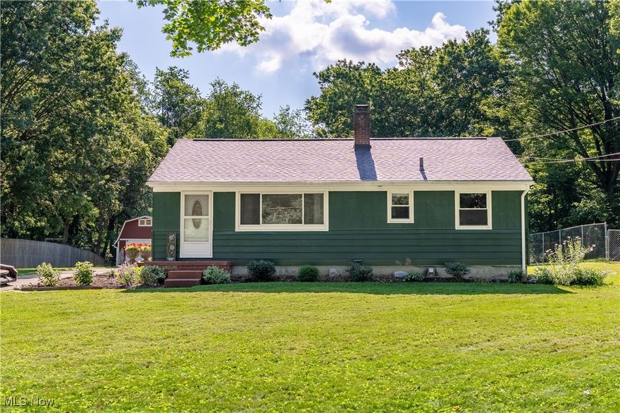 Tucked away on a quiet private lane in Lake Local School District, this charming ranch sits on a beautifully manicured .47-acre lot. A welcoming front porch and thoughtfully landscaped garden beds create instant curb appeal and invite you inside. Step into a bright and airy great room, featuring rich wood flooring and a large picture window that fills the space with natural light. The adjacent eat-in kitchen boasts a stylish art deco tile backsplash with metal accents, crisp white cabinetry, and a cozy dining area overlooking the private backyard. Out back, you'll find a peaceful retreat perfect for outdoor entertaining or relaxing with family and friends, all surrounded by serene views, including raspberry and dewberry bushes along the south side of the shed. Down the hall are three comfortable bedrooms with generous closet space, a full bath, and convenient built-in hallway storage. The home is rounded out by a partially finished basement, complete with an office, a rec room with walk-up access to the attached 2-car garage, and a functional laundry area. Recent updates include a new high-efficiency oil furnace, new roof and gutters installed, an updated electrical panel, and fresh paint on the house both interior and exterior. Don't miss your chance to make this delightful home yours. Schedule your private showing today!