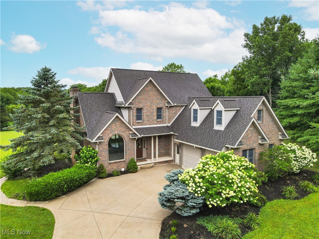 Welcome to Your Year-Round Retreat in Wadsworth! This stunning 4,267 sq. ft. contemporary 4-bd, 4-bath home is nestled on a serene 3.25-acre lot, offering privacy, beauty, and comfort in equal measure. Set back from the road, the stately front elevation is framed by lush perennials and a meticulously manicured lawn. Inside, you’re greeted by an elegant entryway with vaulted ceilings, decorative columns, and a formal dining area bathed in natural sunlight from a large Palladian window. The open concept main floor features a spacious living room that flows effortlessly into the breakfast area and onto the balcony deck—perfect for morning coffee or evening relaxation while overlooking your gorgeous in-ground pool. The smartly designed cherry kitchen includes Corian countertops, ceramic tile flooring, and stainless steel appliances—ideal for both everyday meals and entertaining. The first-floor primary suite is a true retreat, boasting tray ceilings, a spacious en-suite bath with soaking tub, walk-in shower, and direct access to a massive walk-in closet that conveniently connects to the main-floor laundry room. A stylish guest bath is located just off the foyer, along with a staircase leading to the upper level. Upstairs, you'll find two generously sized bedrooms joined by a Jack-and-Jill bathroom, plus a versatile bonus room—perfect for a home office, gym, or hobby space. The walk-out lower level is designed with entertaining in mind, featuring a dry bar, spacious rec area, a fourth bedroom, a full bath, and access to a covered patio—an ideal spot for shaded summer lounging by the pool. And the pool? It’s the crown jewel of the property—get ready for unforgettable summer fun and frequent visitors! Recent Updates: Water Heater '23, Geothermal Furnace & A/C '22, Aerator Pump '20, Pressure Tank (May '25), Septic Pumped (Nov '23). Conveniently located with easy access to I-76 and I-71, this incredible home offers the best of seclusion and accessibility.