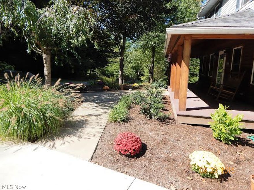 A long driveway winding through woods consisting of six + wooded acres welcoming you to this country charmer. Lamp post will light the way welcoming you home. This home offers a multi-level deck that surrounds the back and side with walkout to enjoy. Hickory wood flooring (real wood) add quality and beauty tot he fantastic first floor living room, kitchen, dining, laundry room and office. Living room is enhanced by the warmth of the gas fireplace and hearth. Home overlooks 2 stocked ponds with fountains and waterfalls. 4 bedrooms and 2 baths upstairs and in the lower level enjoy extra living space with full suite with walkout  and complete kitchen, full bath and appliances. Central air and house generator as well.