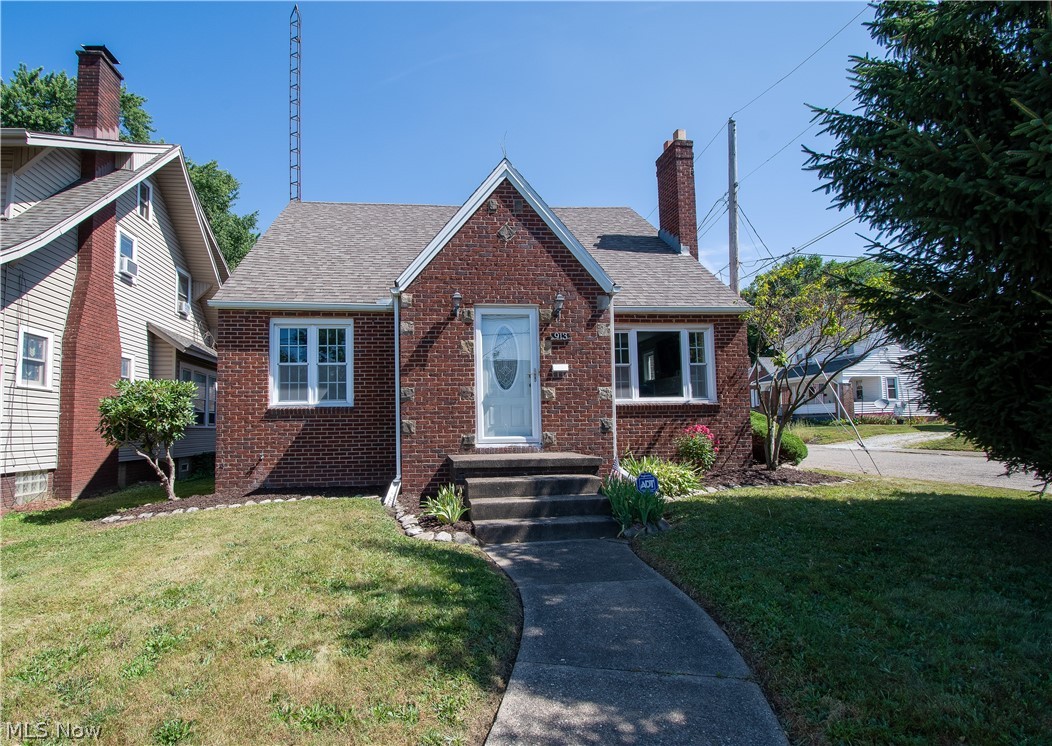 Welcome to this charming three-bedroom, two full baths brick home! This wonderful home is bursting with charm & character. Step into the foyer with two coat closets and lead into the sun-filled living room boasting a beautiful fireplace with a white mantel. The formal dining room includes two built-in corner cabinets. Enjoy the lovely eat-in kitchen with white cabinets accented with Wainscoting walls, a stainless-steel stove, a pantry, and access to the enclosed back porch. Upstairs, the spacious master bedroom offers nearly 9-foot ceilings with hardwood floors, a walk-in closet (9x5), and window nooks for dressers or desks. Both first-floor bedrooms have two closets: deep hallway built-ins plus a laundry chute. The main floor bathroom has a tile shower surround, built-in linen storage, and a vessel sink! A partially finished basement with a huge rec room, a large full bath with a walk-in shower, a bonus/exercise room, a laundry room with utility sink & folding table/counter, and tons