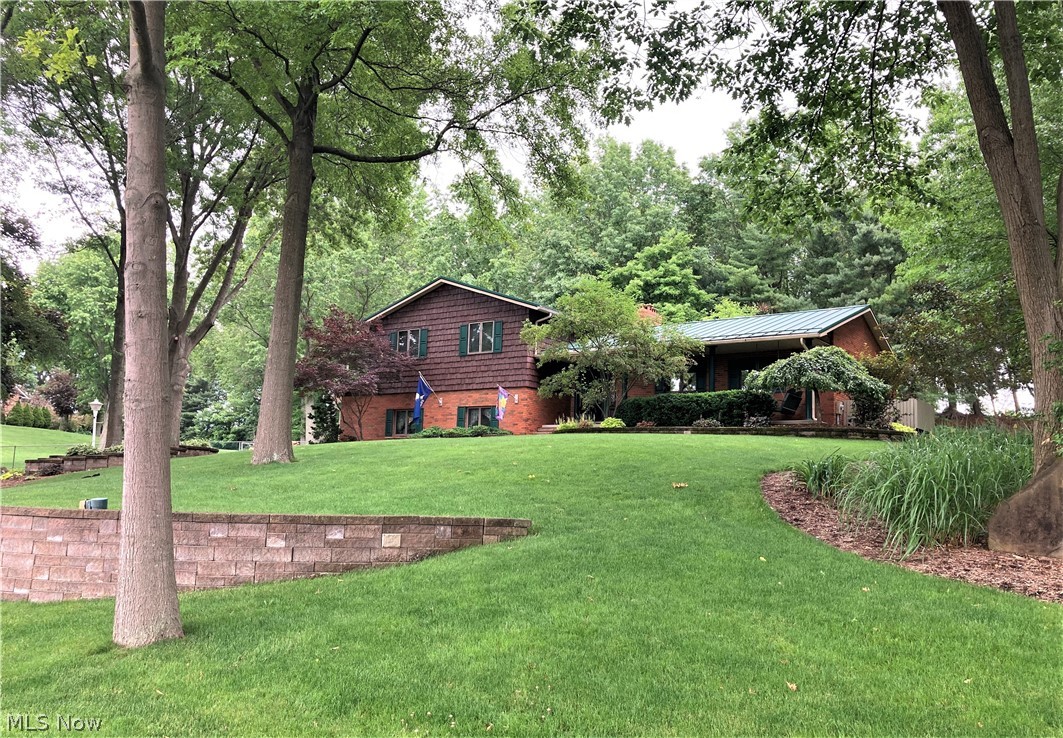 OPEN HOUSE July 11th, 1:00-3:00. This one owner home sits on a park like, private setting at the end of a quiet cul de sac. You will immediately fall in love with the 20x22 Florida room, with a beautiful vaulted wood ceiling, wood burning stove, and french doors that lead into your equally spacious family room. The fireplace is definitely a focal point of the family room, which also has beautiful newer wood laminate flooring. A tastefully decorated living room with great views of the outside, leads into the large dining room - both with beamed ceilings. The kitchen has ample cupboard space and countertops, a pantry, and island. You also have access off the kitchen to a small deck and gas grill! The lower level has a bonus room, complete with a wet bar, and an office with wrap around desk. Plus, there is additional storage space in the unfinished part of the basement. Your master suite is so spacious with a walk in closet, additional closet, and wonderful master bath with a be