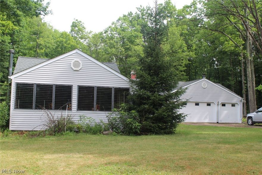 This 3 bedroom, 2 bathroom home gives the cottage feel with the square footage for comfortable living! It is located on Cardinal Lake on 1.6 acres! Talk about peaceful! There is a club house and lake privileges to all in the home owners association. New roof put in the past few years, half the home has new windows,  and half the home has brand new flooring. With a 3 car attached garage and a bonus summer kitchen this place would be a great private, peaceful home with the endless opportunities for summer living!  Don't miss it at the great price! It is priced to sell!!