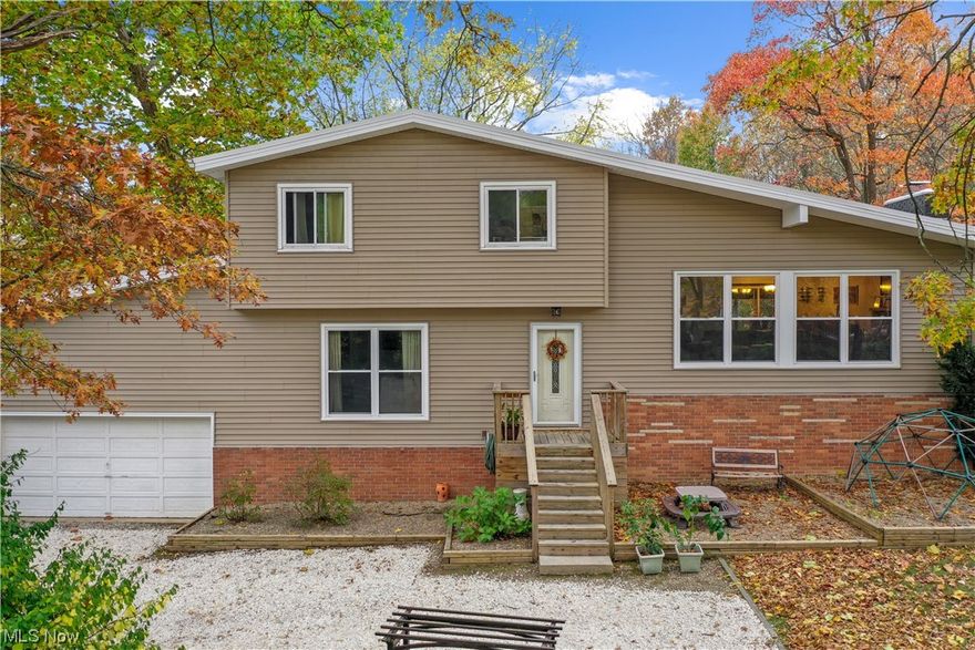 Welcome to this charming split-level home nestled in a park-like setting with a serene creek. This delightful property boasts 3 bedrooms, 2 full bathrooms and an additional room that can serve as an office space, playroom, or fourth bedroom. The great room features beautiful Pergo flooring, vaulted ceilings, and a woodburning fireplace, which creates a warm and inviting atmosphere. The dining room has sliding glass doors that lead to a cozy covered deck, perfect for enjoying your morning coffee. Schedule your showing today!