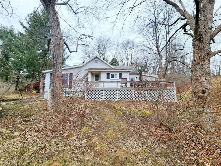 A very private, secluded, and peaceful 5 acres of beautiful property is now available for new owners. This 2+ bedroom, 1+ bathroom home is an estate that the previous owner lived in for over 25 years. This entire property is packed full of potential, just needing cosmetic updates and a good cleaning inside and out! As you enter the property, you will find the long, private driveway paralleled with a large pond. The pond is stocked and has a dock!  Entering the rear of the home you will find a handicap ramp beside the covered back patio. A two car (24'x36') detached garage with an attached carport built in 1999 and oversized 2 1/2 car (20'x24') detached garage built in 1983; one with a wood burner for heat, both with electric & concrete flooring. Updates include bringing the laundry to the first level (laundry connections still connected in the lower level) and updated shower. Major kitchen & laundry appliances, and chicken coop will convey with an acceptable offer. The perimeter of the