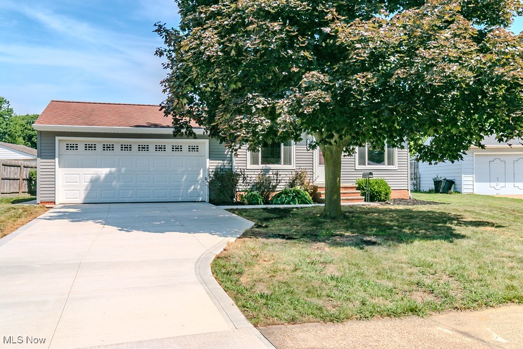 Welcome to this beautifully updated ranch-style home offering the perfect blend of comfort and modern convenience. This home features 3 bedrooms, each with hardwood floors that add warmth and charm. Recent updates include a fully remodeled kitchen, updated full and half bathrooms, newer siding, windows, and a brand new driveway with a walkway leading to the front door. The attached 2-car garage makes leaving the house on snowy days easier and saves you time from scraping ice and snow off your car. Enjoy seamless indoor-outdoor living with a spacious backyard and patio — ideal for relaxing or entertaining guests. The finished lower-level Rec Room features durable nature stone flooring, perfect for gatherings, hobbies, or game nights. Two separate storage rooms in lower-level. A true move-in-ready gem!