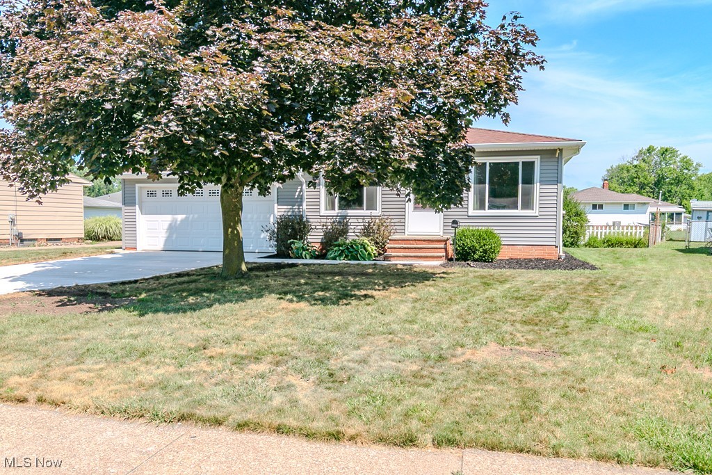 Welcome to this beautifully updated ranch-style home offering the perfect blend of comfort and modern convenience. This home features 3 bedrooms, each with hardwood floors that add warmth and charm. Recent updates include a fully remodeled kitchen, updated full and half bathrooms, newer siding, windows, and a brand new driveway with a walkway leading to the front door. The attached 2-car garage makes leaving the house on snowy days easier and saves you time from scraping ice and snow off your car. Enjoy seamless indoor-outdoor living with a spacious backyard and patio — ideal for relaxing or entertaining guests. The finished lower-level Rec Room features durable nature stone flooring, perfect for gatherings, hobbies, or game nights. Two separate storage rooms in lower-level. A true move-in-ready gem!