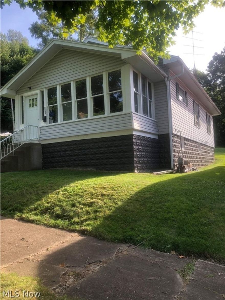 Updated and MOVE IN READY! You can enjoy your morning coffee on the enclosed front porch or marvel at the refinished, original hardwoods that highlight the main floor. The kitchen and bathrooms have been updated with new laminate plank flooring and other updates to finish them off. The interior features new paint throughout, along with new front and rear exterior doors. Great home for downsizing or INVESTMENT! This will not last long, DO NOT MISS OUT!!! When rented out, this home brought $700 a month.