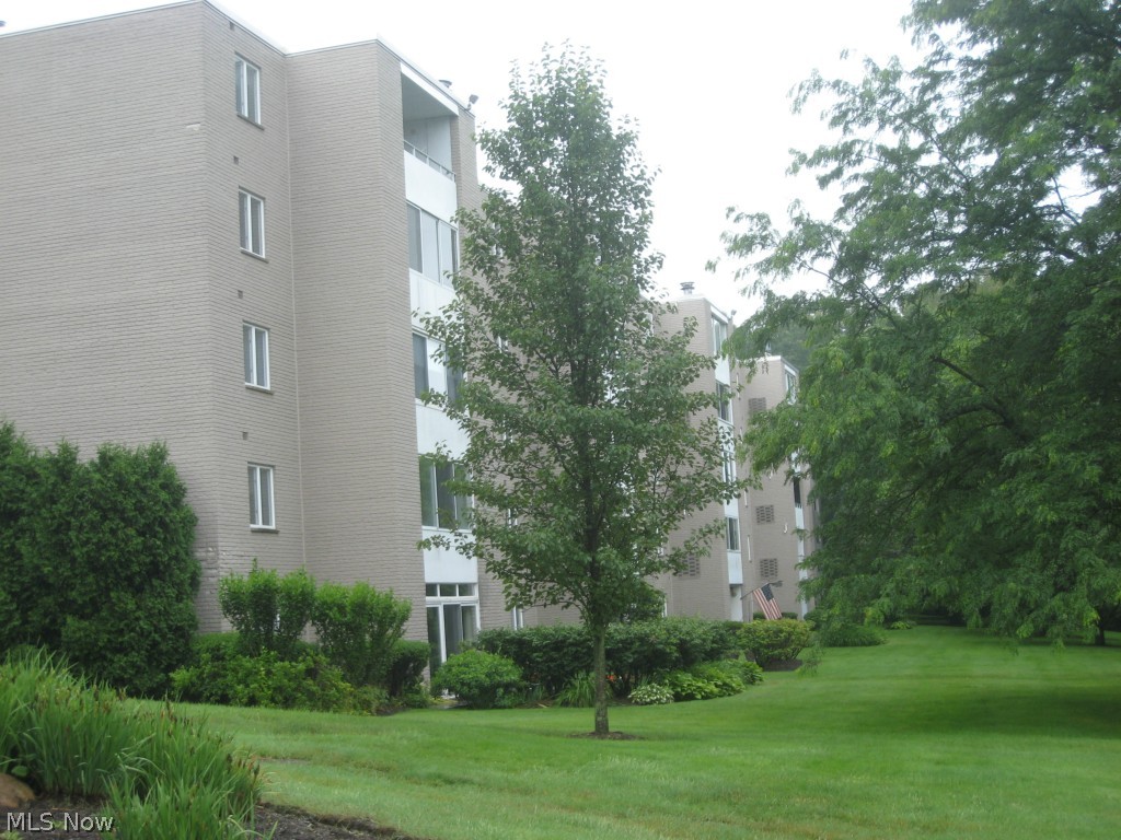 Nestled in the trees, this end unit overlooks the park on 2 sides. Walk in to the foyer of this beautifully maintained unit that has been thoughtfully improved. The seller wanted to take advantage of the end location and views of nature, so opened the porch and made it year round and open to the living room. At the other end of the living room, made a cozy family room/office that could be a small bedroom. Gorgeous cherry kitchen with lots of cabinet space and countertops. Newer appliances, too! Good size master bedroom with walk in closet. In suite laundry with stacked washer/dryer combo stays. Amenities include Community Room, Exercise Room, Library/Craft Room and pool. All utitlities included except for sewer which is a quarterly bill. This is a secure building with inside parking. This is a beauty. Call to see.!