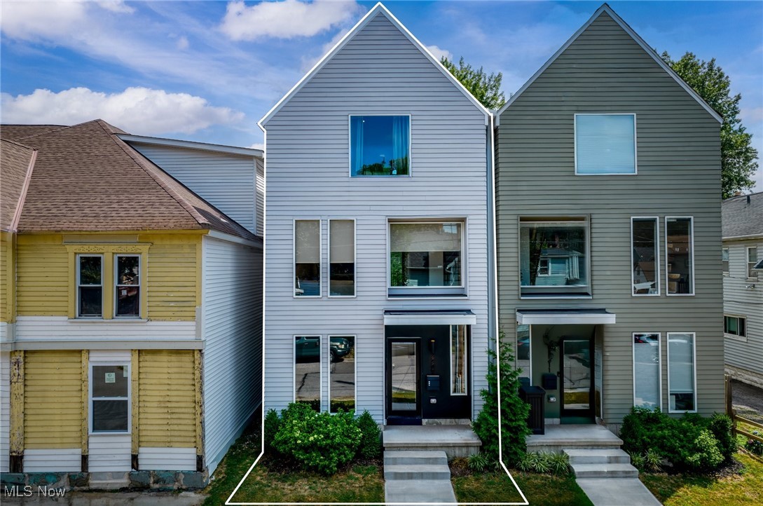 Sophisticated and basically-brand-new construction in the Heart of Ohio City’s Solo neighborhood! Ideally situated on a charming, tree-lined street in one of Cleveland’s fastest-growing neighborhoods that's walkable to both Fulton and Lorain's growing retail districts. And, what's more? FULL City of Cleveland green-energy tax abatement through 2038!! Step inside and be impressed by the bright, open-concept living spaces featuring wide-plank luxury vinyl flooring, designer finishes, and expansive windows that flood the home with natural light. A convenient first floor bedroom currently flexes as a home office space. Up one level, discover a gourmet kitchen boasting sleek quartz countertops, custom white shaker cabinetry and full suite of premium stainless steel appliances. Off the main living area kitchen is a private deck that provides the perfect space for entertaining or relaxing outdoors. The kitchen seamlessly opens to the dining and living areas, which feature a stylish accent wall and stunning windows with brand-new treatments. Upstairs, the third-floor owner’s suite is a true retreat, offering vaulted ceilings, a walk-in closet, and a spa-inspired bath with a large double vanity and custom-tiled walk-in shower enclosed in glass. A second bedroom, full guest bath and convenient laundry area complete the upper level. Spacious two-car attached garage has ample storage as well! With thoughtful design, high-end finishes, and a prime location near restaurants, shops, parks, and downtown, this W 33rd townhome offers an unbeatable opportunity to own almost-new construction in one of the city’s most desirable neighborhoods.
