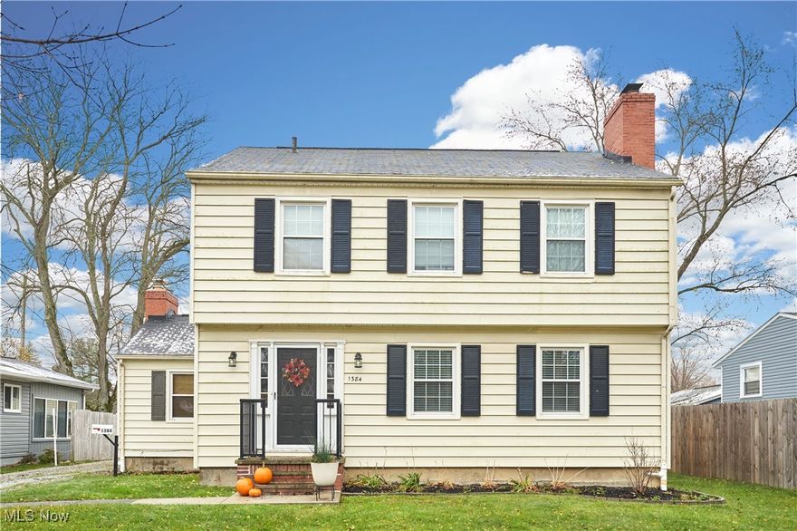 Welcome to this spacious and beautifully maintained colonial-style home offering over 1,800 sq ft of living space, plus a large 25x22 two-car detached garage. Step inside and be greeted by a light-filled formal living and dining room featuring hardwood floors, crisp white trim, large windows, and a classic wood-burning fireplace—ideal for everyday living and entertaining. The updated kitchen combines style and function with stainless steel appliances, laminate flooring, and a convenient water filtration system. Just off the kitchen, the cozy family room invites you to unwind with neutral carpet, built-in shelving, and a brick-surrounded ventless fireplace (2014). A tastefully updated half bath completes the first floor. Upstairs, the spacious primary suite features an en-suite bath with a brand-new shower. Two additional bedrooms offer generous closet space and share a beautifully refreshed full bath with an updated tub/shower. The lower level provides a large basement with laundry, workshop area, and tons of potential for storage, a gym, or even more finished living space. Enjoy outdoor living on the back deck, perfect for entertaining, all within a fully fenced backyard with white vinyl privacy fencing (2017/2023). Additional updates include many new windows (2017), furnace (2018), interior paint (2020), and more—ask for the full list! Ideally located just minutes from schools, parks, shopping, and restaurants. Don’t miss your chance to own this West Akron gem—schedule your showing today!
