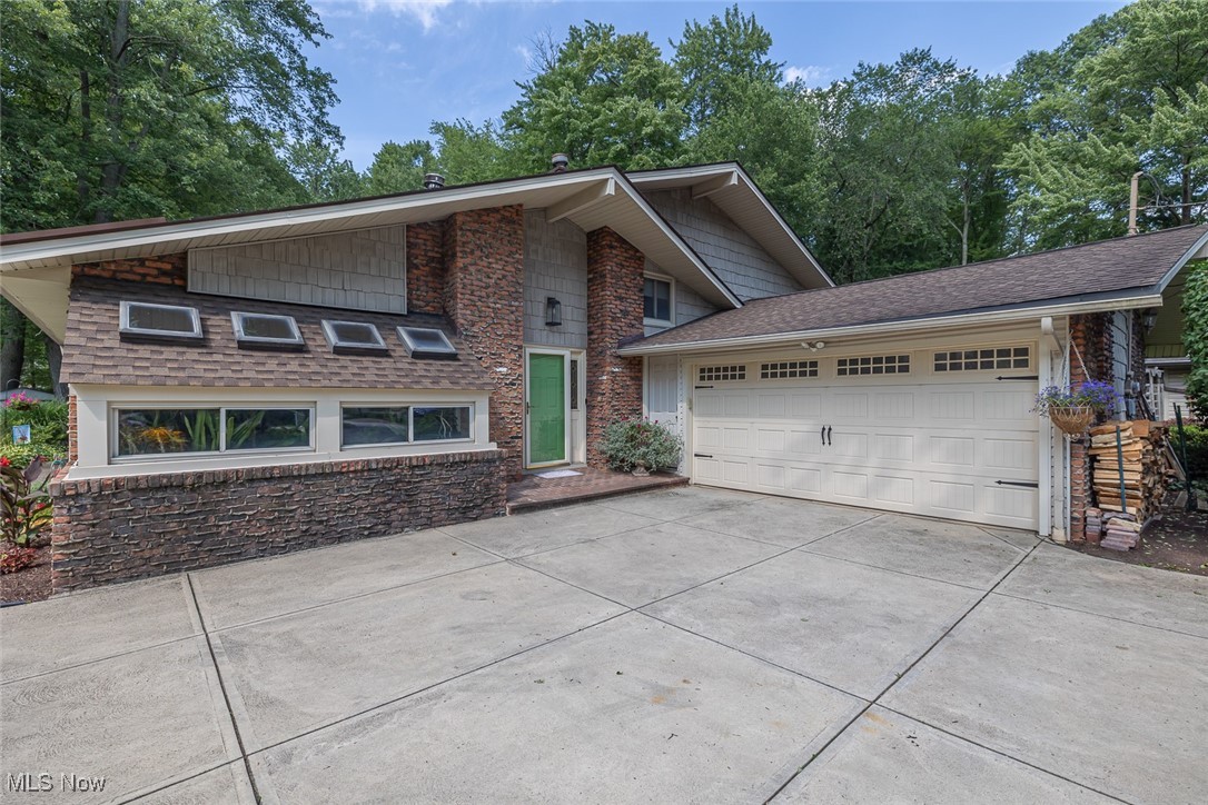 WHERE DO WE BEGIN!!!! This very nice home sits on almost an acre of land (.91) that backs up to the METROPARKS!!! These do not come up very often. We are a Split Level with a very welcoming entrance foyer, with 5 Bedrooms, 2-1/2 Baths, Formal Living and Dining rooms, Updated Eat-in Kitchen with all newer appliances, seven years ago. The Living Room offers a free standing fireplace and a wonderful Atrium for all of those plants that you may want to nourish. This completes the ground level. As we continue upstairs you will see four bedrooms and two full baths. As we venture out through the Pella sliding doors you are entering into the three season sun room and then from there you enter into Paradise.... The owners have put a lot of sweat equity into making the outdoors their OASIS.. There are three decks, gazebo, small fish pond, green house, and a covered canvas over the Barbeque Grille area, The front yard is just as beautiful with a turn around driveway. Some of the upgrades are as follows. The roof was replaced 5-8 years ago, HVAC 12-14 Years, Windows 15 years and the hot water tank, 2025. The washer and dryer are 5 years old. It's your call to act on this quickly or to sit back and see it taken away from you!!!!
