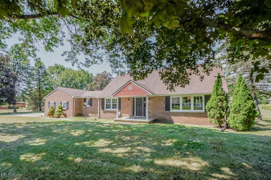 Enjoy peaceful country living in this brick 4 bedroom cape cod in Louisville schools! Well cared for updates include a newer furnace, A/C, windows, septic system, water filtration, and 200 amp electric. Inside, natural light fills an open floorplan with neutral decor. The living room off the foyer features laminate flooring that continues into the eat-in kitchen, which shines with granite countertops, breakfast bar seating, stainless steel appliances, and plenty of soft-close cabinetry. A nearby family room keeps everyone connected and has a wood-burning fireplace for relaxing evenings. One main floor bedroom has access to a full bath, and the laundry room with washer/dryer included is conveniently located nearby. Upstairs, three nice sized bedrooms with hardwood floors share a full bath with a deep soaking tub. The waterproofed lower level adds extra living space with a kitchenette, bonus room, and another full bath. Outside, a tiered deck overlooks the spacious yard, firepit, and shed. The two-car garage includes a separate 150 amp electric service, gas line for a heater, refrigerator, two safes, new lighting, and garage door openers. With so many thoughtful updates and spaces to enjoy, this is a home you'll want to see!