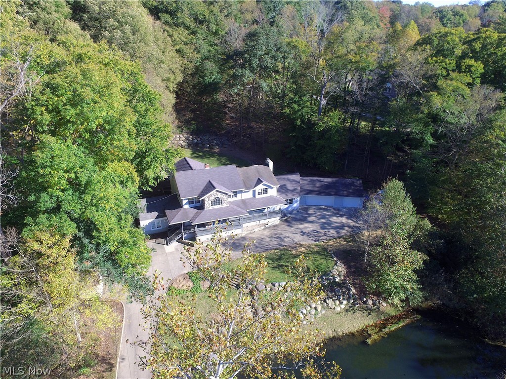 This beautiful home sitting on a 1.77 acre lot is located in a very desirable location. It is less than 5 Min from Portage Crossing offering diverse dinning options, the market district and other retail stores. It is also near many of The Valley Parks, which include Cascade Valley Metro Park , Sand Run Metro Park and Hampton Hills Metro Park. From the charming front porch you can view The Mud Brook river across the street as well as your very own stocked pond. Walk inside to find New Carpet and paint throughout, New vinyl plank flooring (waterproof and soundproof) in Kitchen, Dining and Bathrooms. Updated Bathrooms, an office/5th bedroom on first floor, spacious family and living room, Large kitchen featuring Custom Kraftmaid Cabinets with roll out trays and shelving. Upstairs offers a Huge Master bedroom with cathedral ceilings and large master bath, large walk in closet and additional linen closet. Other attractions of this home include the Theater room on 1st floor, perfect for en