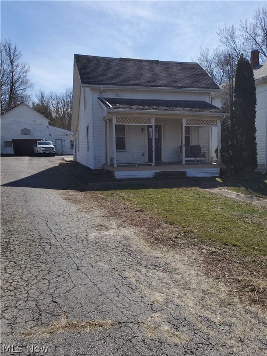 Investor Special!  This home features 2/3 bedrooms, 1 bath, large rooms, paved driveway and large 2 story garage.  Work has been started, just needs a little more TLC.  Sold as is.