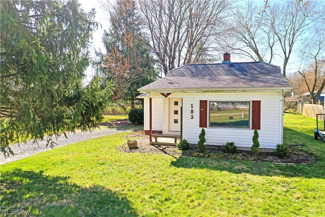 Perfectly cozy and potential packed, all accompanied by tasteful updates; this move-in-ready, one bedroom Champion home might be just the one you’ve been looking for! Located in a desirable local neighborhood that keeps you within quick access to local attractions, the ample lot extends from the quiet side street a tall pine trees provide an added touch of natural privacy and shade alike. A tiled foyer awaits you at the front door, spilling into the nearby kitchen with its countertop serving window. Meanwhile, a spacious living room enjoys plenty of natural light that washes across its carpeted floors. A tastefully updated full bath offers a glass block window for sun filled bathing while a stylish vanity looks on. The gracious kitchen provides ample dining space as its green countertops add a splash of color. Opposite the living room, the inviting bedroom includes a large closet with built-in shelving. A full basement presides below with storage and utility access.