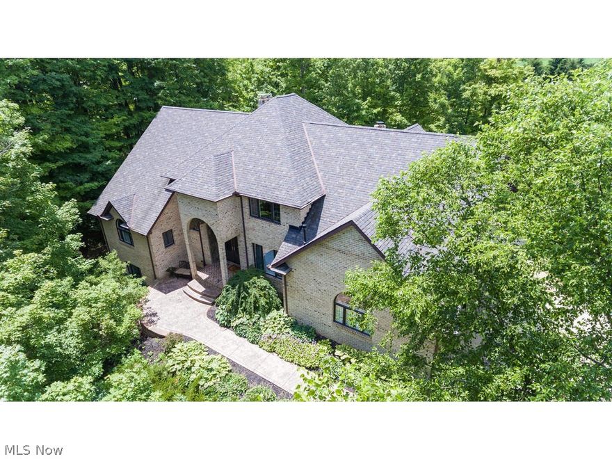 Your search for peace & serenity w/all the amenities ends here with this gorgeous 4 BD/4 full & 2 half bath country estate privately situated on 5.71 acres.  Nestled in the heart of Richfield Twp, this brick & cedar home offers easy access to  Revere schools, dining & shopping, and just a short drive to the airport. You will enjoy the open floor plan w/defined spaces flooded by natural light through large windows. The kitchen boasts generous granite counters, storage and cabinetry, a new Wolff cook-top, a two-tier island & vaulted ceilings, as well as a cozy fireplace and views of the beautiful property. A formal Great Room and dining area off the kitchen are the perfect places to entertain guests.  The office features grand built-ins and gorgeous views through the over sized windows. At the end of the day, retreat to your first-floor master suite to relax and unwind. The 2nd floor features two large bedrooms w/private baths & loft overlooking dramatic views of the first floor.  Abunda