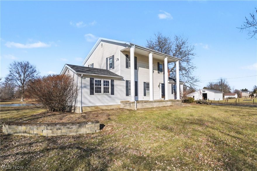 Nestled in the heart of South Range School District, Twin Willow Farm unfolds like a tale of endless possibilities. Across 15 acres of versatile land, a 12-stall center-aisle barn and sand based round pen and pastures stand ready for your livestock or equestrian dreams. Fish glimmer in serene ponds, while every building-now crowned with newer dimensional shingle roofs-whispers craftsmanship. And best of all there is free gas which means warm winters and energy savings year round. Inside this colonial style home you will find 3 bedrooms, 2.5 baths, a large first floor office, both living, family room, dining room and at the heart of the home a custom maple kitchen crafted from raw lumber with elegant crown and dentil molding-making a statement. Full-extension drawers, pull-out pantry shelves, and dual dimmable zones (with cozy under-cabinet lighting) create a warm, functional haven. This property doesn't just offer a lifestyle-it offers potential. You will appreciate the walk-out basement and having a 5 car garage with an upper level to open up so many options. You're just 10-15 minutes from retail and dining, close to Canfield Fairgrounds and Garwood Arena, and easy access to Beaver Creak State Park and Buckeye Horse Park. This property offers a private rural setting, yet not cut off from the world. Schedule your private tour today. We will love seeing the memories you will make!