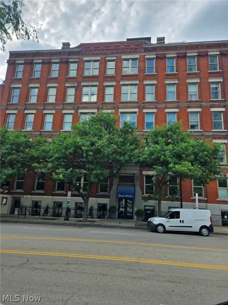 Historic brick building featuring a stone entrance archway and a prominent street-level entrance