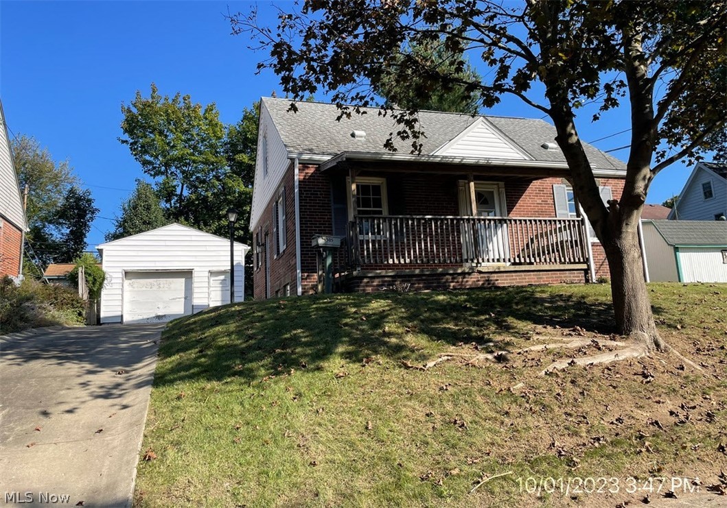 A cape cod style property with a kitchen, living room and 2 bedrooms on the first floor, and a third bedroom on the second floor. This property also features a concrete driveway and a one car detached garage.