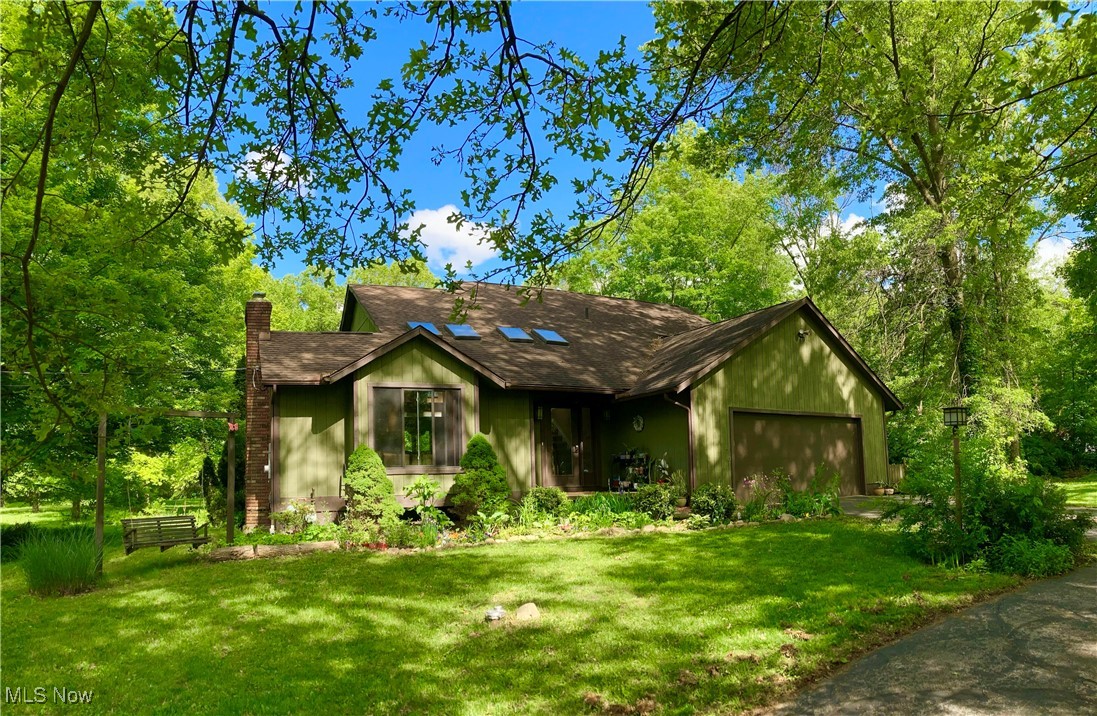 Imagine waking up to the serene embrace of nature, where your home is nestled within a tranquil, park-like sanctuary, offering breathtaking views of lush, mature woodlands. This spacious home features expansive windows and brand-new skylights that invite abundant natural light. The living room and entrance boast cathedral ceilings, enhancing the sense of space and grandeur. An eat-in kitchen and gas fireplace provide focal points for comfort and ambiance, both overlooking the wraparound deck.
The first-floor master suite offers a large walk-in closet and remodeled en suite bath; the second floor boasts three bedrooms, a loft/office area, and a full bath. In the basement is the laundry area and lots of storage space, with even more storage space in the huge attic above the two car garage. The A/C and heating is forced air; the furnace was new in 2015. You'll benefit from the peace of mind provided by a brand-new roof, installed in July 2025, ensuring years of worry-free living. The private well and septic systems have had recent, thorough inspections, both receiving excellent reports, confirming their optimal performance and reliability; the septic tanks were pumped in July 2025. This home offers not just a place to live, but a lifestyle of tranquility, beauty, and modern convenience, all within your own private natural oasis.
We love the vaulted entrance, large casement windows, designer chandelier, narrow-wood hardwood floors, the large circular tree-lined driveway, and the quiet natural setting amid lots of mature trees. And it’s just minutes from NEOMED and I-76.