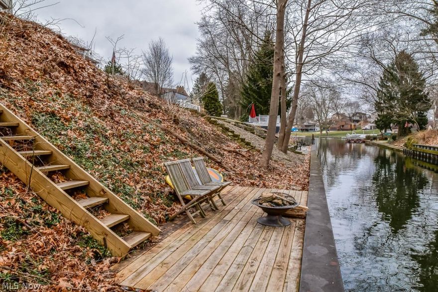 Picturesque 1700 sqft 3-4 bedroom home with 2 full baths and a finished, walkout lower level on Portage Lakes! Incredible attention to detail with shiplap accents, updated light fixtures and rustic wood finishes! Waterproof luxury vinyl plank flooring on the main level plus plush carpet throughout the upper and lower level. Find your culinary inspiration in the sun-filled eat-in kitchen with granite countertops, soft close cabinets, stainless steel appliances, dove tail drawers and a gorgeous wood plank ceiling! Enjoy meals in the casual dinette or in the formal dining room with a custom beamed ceiling. Gather in the back living room with an oversized 8-foot sliding door to the deck. The room is L-shaped with an adjoining bonus room perfect for an office! Off of the living room, there's a stunning full bath with marble countertops. Upstairs, the master bedroom has a sliding barn door to an ensuite full bath with a tiled shower. Second bedroom across the hall with built-in bench storage