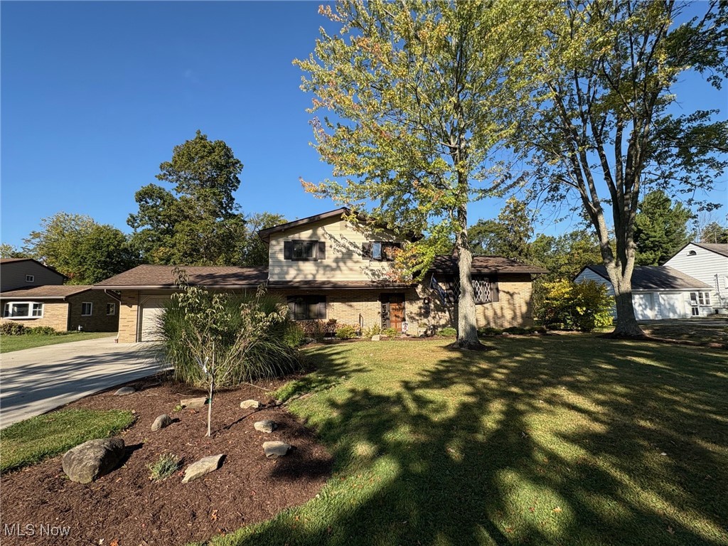 Move Right into This Nicely Updated Four Level Split! Over Half an Acre Parklike Setting! Sits Back Off Road with Double/Triple Wide Newer Concrete Driveway & Additional Parking Pad for RV, Camper or Boat! Rich Foyer Entrance with Hardwood Flooring and Solid Wood Doors! Living Room has a Bow Window! Dining Room with Hardwood Floor & Slider to Double Tiered Deck the Awning with Table & Chairs will Stay! Updated Eat-In Kitchen Has Newer Gas Stove, Dishwasher and Top of the Line Fridge that Stays! Built in Dinette w/Table & Chairs! Family Room with Slider to Patio w/Built-in Roll-Out Awning! Overlooking Amazing Backyard! Family Room has Fireplace with Wood Burner Insert! Office/Den off Family Room Coming in from Garage has Built-in Desk & Shelving! Master Bedroom with Spacious Walk-in Closet and a Second Closet for the Rest of her Stuff! Second Bedroom Has Double Closets. The Main Bath Was Recently Updated with a Step-in Shower, Newer Vanity, Sink & Flooring! The Basement has Built-in Shelving, Glass Block Windows & Newer Hot Water Tank! Gas Furnace & Central Air Conditioning! The Washer & Dryer Stay! Newer Roof! Two & a Half Car Attached Garage w/ Opener and Hot/Cold Water! Newer Sanitary Sewer Liner & Drain Lines for Gutters! Backs to Wooded Area with No Close Neighbors! Check this one Out! Quick Possession is Available! One Year Warranty Included!