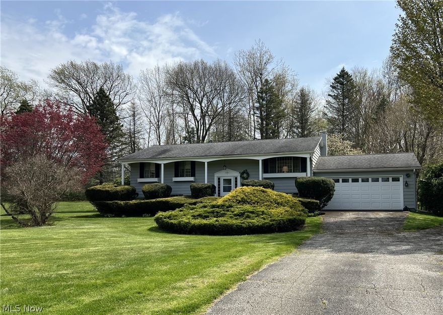 Over 2,000 sq ft of living space in this raised ranch with full finished basement.  3-bedrooms,a full bath, kitchen, dining and living room on the main floor.  Family room with wood-burner, full bath, office with built-in bookshelves and laundry room on the lower level that walks out to the 2-car attached garage.  Great solid home that has been very well maintained.  Deck off the kitchen and covered patio below.  Updates include Breaker box 2023, aluminum siding painted 2019, gas range 2024, washer and microwave 2023. Home has city water and central air.   A great home with wooded view on 1-acre in Buckeye Schools. This property is located in Kingsville Twp but has a Conneaut mailing address.