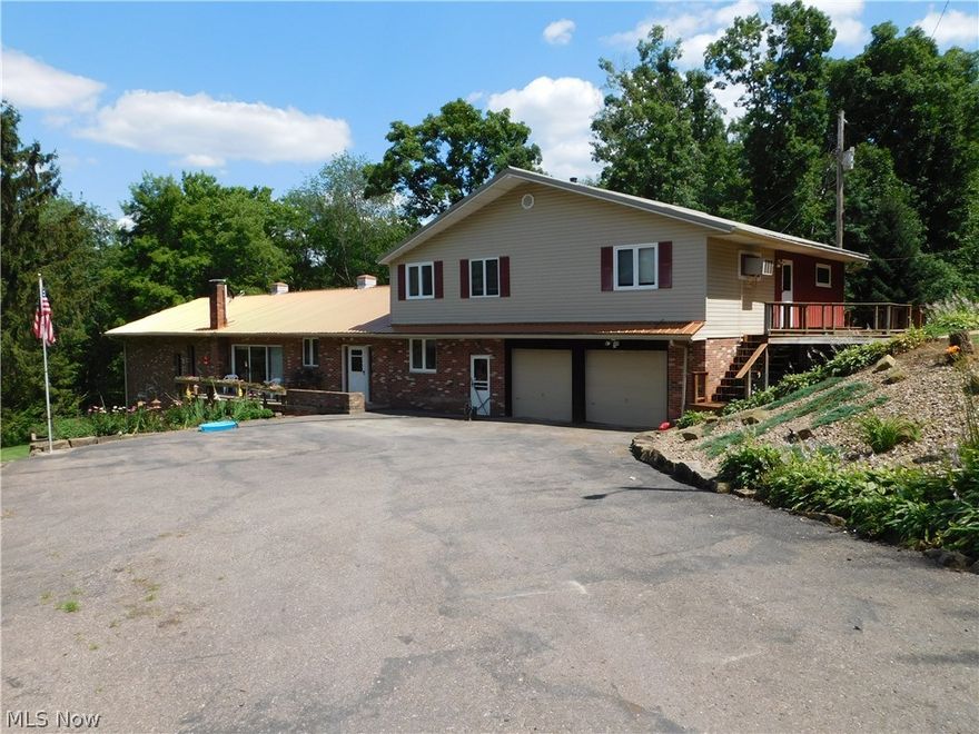 Secluded brick home situated on 9+ acres conveniently located midway between Millersburg and Coshocton. The 3,640 sq. ft. home offers a 5 bedrooms, 4 baths, 1st floor laundry, office, kitchen, living room and a full height from basement to roof great room with floor to ceiling windows and large fireplace with a wood stove. Above the attached 2 car garage is a 3 bedroom, 2 bath apartment with a kitchen and dining/living room area. Property has 2 septics and a natural spring as the water supply. Outbuildings include a 30'x40' pole building and a smaller block building. The home sits back off the road surrounded with woods with a creek flowing through an open meadow.