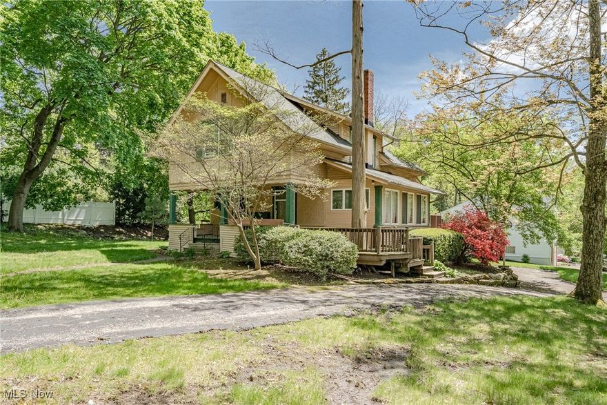 Welcome to 1056 Garman Rd – This 3-bedroom, 1.5-bath home is full of charm and character, offering a rare opportunity to restore a classic property in one of Akron’s most sought-after locations. Step onto the delightful front porch and into a welcoming foyer featuring a bay window and built-in bench. The spacious living room boasts an impressive stone fireplace and opens to a sunny bonus room, perfect for a home office or cozy reading nook. Enjoy the eat-in kitchen with plenty of cabinet space, and a large family room filled with natural light and sliding doors leading to the back deck. A convenient half bath is located on the first floor. Upstairs, you’ll find three generously-sized bedrooms and a full bath. The full basement connects to the attached 1-car garage, offering great storage and workspace. Outside, a large fenced-in area in the backyard provides privacy and room to play or garden. This home needs TLC, but the potential is undeniable—don’t miss your chance to make it shine!