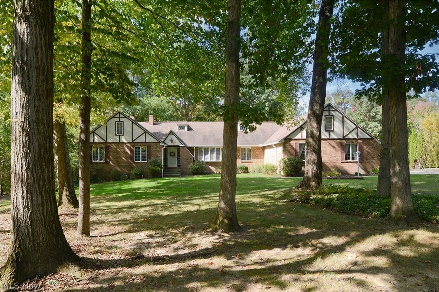 Wow! Looking for an awesome home with plenty of space? One that has a lot of special features you may really fall in love with? Nestled on Whispering Pines, This home boasts a serene location with woodsy backyard setting, easy maintenance landscaping, an attached three car garage and plenty of driveway space with additional parking available. Spacious foyer entry leads to sunken carpeted living room, oversized dining room and spacious kitchen with dinette area, appliances to stay, great counter space for meal prepping and plenty of cabinets with loads of storage! Huge first floor family room with beamed vaulted ceiling, a wet bar, built in shelving, gorgeous brick fireplace and slider doors leading to an enclosed three season room to enjoy those gorgeous wooded views and the wildlife that comes from this setting!  First floor master suite with private full bath and walk in closet! Second bedroom and another full bath on this floor as well. Half bath with previous business as a small sa