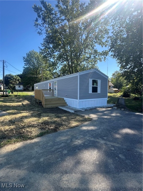 Welcome to your brand-new home in a quiet, well-kept community in Orrville! This newly constructed Clayton Tru Delight manufactured home offers 2 bedrooms and 2 full bathrooms across 820 square feet of comfortable, efficient living space. Everything here is brand new, inside and out. The home features a modern, open-concept layout, new appliances, and quality finishes throughout. Enjoy relaxing on your new front deck with space for seating, and convenient back steps leading to your private yard area.  Located on Lot 16, this home has a monthly lot rent of $400.00, with the new owner responsible for water, sewer, electric, and trash services. This home is move-in ready, beautifully finished, with appliances, and perfect for anyone seeking affordable new construction in the Orrville area.