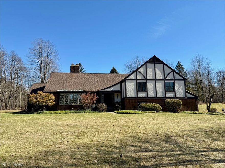WELCOME HOME to this Sprawling Multi-level Tudor-style home nestled on nearly 3 Park-like Acres! This spacious home boasts over 3600 sqft of living space with 4 Bedrooms & 3 Full Baths. Main level living includes welcoming Foyer entrance, large Living Room with fireplace, Dining Room with hardwood floors and access to 4-Season Sunroom with ceramic floors. Updated and well-appointed Kitchen with abundance of cabinets & corian counter space, bay window, hardwood floors, stainless steel appliances including double oven & gas cooktop. Dining area with sliders to brick patio & walkway. Upper level includes Master Bedroom with new carpeting, walk-in closet & private balcony overlooking pond and private backyard. Totally remodeled Master Bath with all new flooring, fixtures, sink, vanity & oversized spa-like ceramic shower. 3 additional generous sized bedrooms & full bath complete the upper floor. Step down to the gracious Family Room with new carpeting, fireplace with wood burning insert and laundry area with cabinetry. Great storage throughout includes generous closet space, huge attic & unfinished basement with access to the deep 2+car attached garage. Central air. Generac generator. Concrete driveway with plenty of parking/turnaround. Nicely situated in Munson Twp....Just minutes west of Chardon Square, close to shopping, restaurants, community parks, golfing, Chardon Schools, NDCL and more! 1-yr home warranty. This wonderful home is ready for your growing family to make memories of their own....Immediate Occupancy!