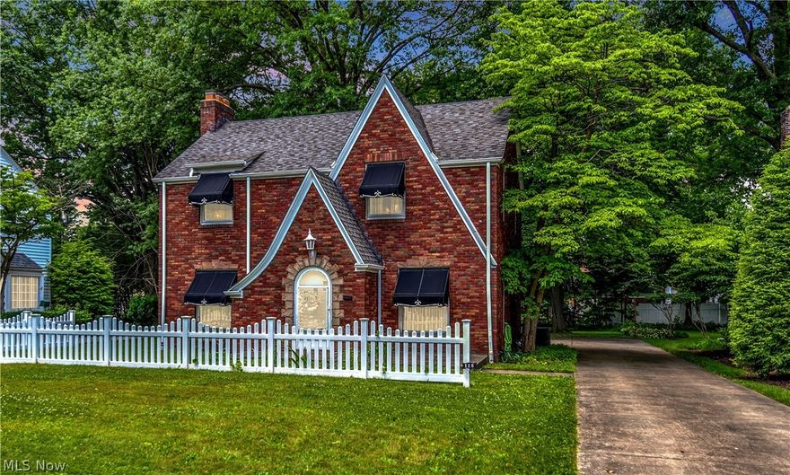 A Brick Tudor home loaded with character and charm within the blocks of the "Historical Forest Glen" district of Boardman. The stately awnings and white vinyl fence add great curb appeal.  A Neighborhood with sidewalks and street lamps, steps away from Mill Creek Park and the first Handles Ice Cream. This home has been well maintained and shows pride of ownership. Original moldings, arched doorways, leaded glass windows and gorgeous hardwood floors throughout with Persian wool carpeting in Living Room and Dining Room with hardwood underneath. Equipped spacious kitchen, dining room with built-in china cabinet, a wood burning fireplace in the Living Room and a 1/2 bath tucked away.  Second floor is three nice sized bedrooms with exposed hardwood floors and a full bath.  
The basement offers a finished rec room on one side and laundry area, a shower and storage on the other.  Two car attached garage, concrete driveway and a nice private backyard for entertaining. Roof and Drive-way were