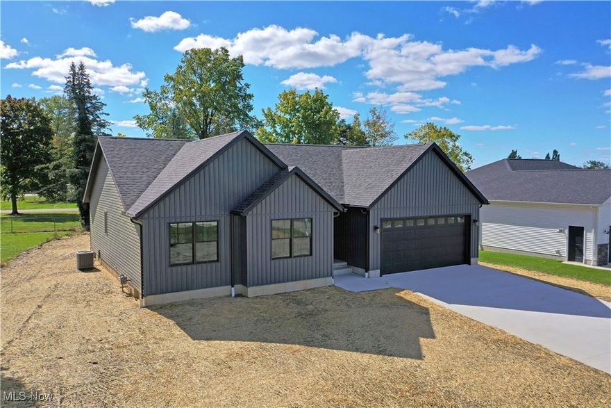 Sleek modern styling and a generous open floorplan awaits this showstopping new Cortland construction! Located within a highly desirable local neighborhood, this home puts you just seconds away from multiple downtown attractions, taking full advantage of its prominent location to bring a sizeable yard and cement rear patio. Dark colored siding is paired with black trim and accent work for a deep, moody look. A recessed entryway opens to reveal a hall-like foyer as a second hallway branches away towards the bedrooms. Stepping into the central great room, sunshine pours through the array of windows to warm the hardwood-styled flooring below. Stepped ceiling marks the living room portion where gas fireplace is met with a stunning mantle. Bespoke lighting choices continue through central dining to find a remarkable kitchen with its wide, polished stone countertops and bright stainless appliances that contrast the darker cabinetry. First floor laundry is located near garage access. Down the main hall, a pair of brightly lit guest bedrooms continue with ample closet space. They are joined by a handsomely appointed full bath, set before the master suite. Here, a large walk-in closet joins a second, full private bath with a floor entry shower. The oversized bedroom completes the floor. Downstairs, formed concrete walls surround plenty of storage space.