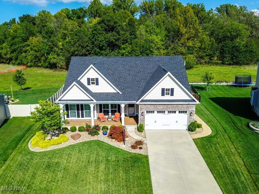 Prepare to be captivated by this 4 Bed/3 full bath Luxury Ranch in Hunting Meadows Subdivision in Columbia Station. Built in 2019, the large, ranch-style home you've been dreaming of with a finished basement and private backyard is waiting for its next owner. Exceptional curb appeal, a full-yard irrigation system, and a covered Naturestone front porch welcome you. The true showstopper is the private, fenced-in backyard backing onto a wooded lot. Enjoy the Trex deck and two under-house storage rooms for all your outdoor needs. An elegant foyer introduces the spectacular open-concept layout. The sun-drenched living room with a wall of windows flows seamlessly into the spacious eat-in kitchen, which features a center island, plenty of countertop space, all stainless-steel appliances are included, and an abundance of cabinets for all of your kitchen storage needs. Dining area is also surrounded by windows and opens to the deck and enclosed patio room. The Primary Suite is a sanctuary with a trayed ceiling, a walk-in closet, and a newly remodeled private en-suite with a walk-in shower and double vanity. Two more spacious bedrooms and a separate full bath are thoughtfully placed across the hall for privacy. A convenient first-floor laundry room and mudroom complete the main level. The expansive, finished basement nearly doubles your living space. It includes a massive recreation room with large double door closet, a generous lower-level 4th bedroom, a versatile bonus room/office, and a 3rd full bathroom! Plenty of storage space awaits in the unfinished utility/storage room and a workshop area with large window at ground level. Radon mitigation system thoughtfully installed when built. This home delivers comfort, space, and style. Home Warranty Included! It’s ready for you to move in and enjoy! Set up your private showing today.
