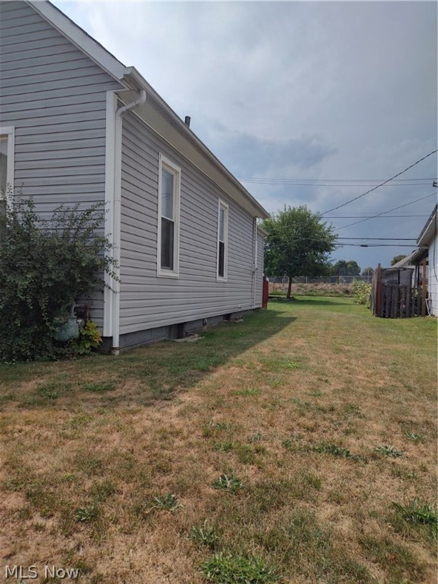 One Bedroom up, 1, possible 2 on the main floor, living room, kitchen and laundry on the main floor.  Unusual corner cabinet in the kitchen.
Rear of home faces the fair grounds.  Garage area has had the door modified and would need a larger door for an automobile.
Newer ramp enters the rear of the house into the laundry area.

House is selling "AS IS"