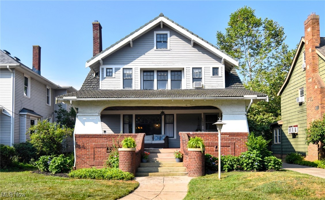Extraordinary four-bedroom Craftsmen on a quiet Lake Erie street in Cleveland's vibrant North Collinwood community. Exceptional workmanship throughout, with original hardwood floors, artful leaded windows, gorgeous built-ins, period fixtures and hardware. Tall ceilings and abundant natural light. The first floor features and oversized living room with a focal point fireplace opening up to a large, elegant formal dining room perfect for hosting large gatherings. French doors open to an intimate sitting room or den - the perfect spot to enjoy a good book. The classic, bright and open kitchen provides for more functional movement than you typically find in a home of this era, with a charming breakfast nook, plenty of workspace and storage, and a pantry area leading out to the back door. A conveniently located half bath with its beautiful original tiled floor is found between the kitchen and living room. A wide staircase leads you up to the second floor, where you'll find a primary bedroom with deep walk-in closets on each side of the room. Down the hall and you'll find three more amply sized bedrooms, all with adequate storage. The back bedroom features a private covered outdoor balcony overlooking the backyard. You'll also find the archetypal 1920's full bathroom, replete with subway tile and a substantial pedestal sink. The finished basement area boasts a second fireplace, hardwood floors, built-in shelving, and a small kitchenette area. The mechanical area features laundry, an oversized utility sink, and another full bath. Finished attic for extra storage or play space. Private, shaded, and fenced backyard. Steps down the street you'll find a peaceful lakefront park with seating, pavilion, and playground. Easy access to Lake Erie, parks, shopping and entertainment, hospitals, and the highway. New boiler 2022. New hot water tank 2021.