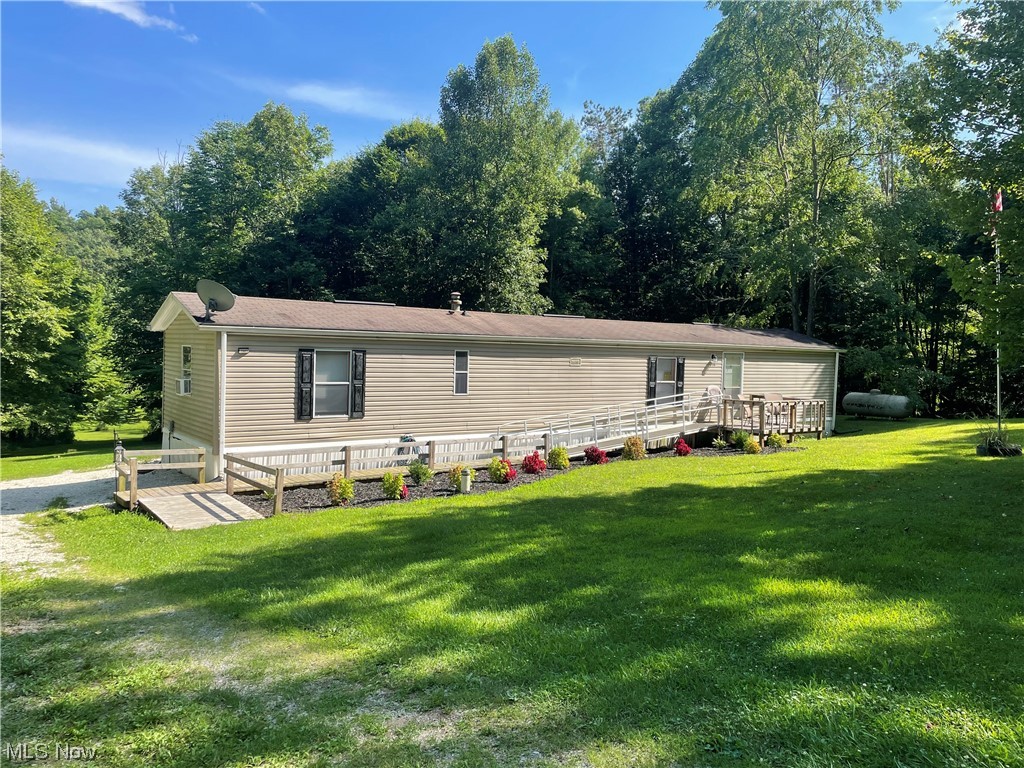 Over 7 acres with remodeled manufactured home in Carroll County. Perfect home to move right in or for a country weekend getaway! Featuring a large screened in back porch, 2 large bedrooms, eat-in kitchen and handicap accessible bathroom this is a one of a kind find. This home has been an active Air BNB rental for 2 years with solid income and ratings, as well as low operating costs. Home is being sold furnished with everything you need to continue renting for short term rentals or to move right in! Located within 15 minutes of Tappan, Atwood and Leesville Lakes, the private location is unmatched and is a hunter or fisherman's dream. Land has some marketable timber. This property is the perfect mix of open space and woods with a stream running through. Property is Agent Owned.