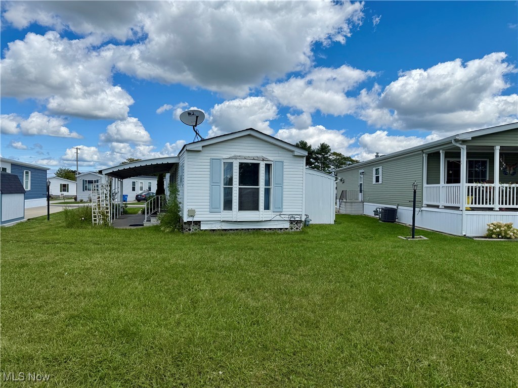Enjoy peaceful lakeside living in this well-maintained 1996 Astro model manufactured home located in the desirable Pikewood Manor community. This inviting residence offers two bedrooms and two full bathrooms with a thoughtful layout designed for both comfort and convenience. The bright primary suite has a bay window overlooking the beautiful lake, creating a serene retreat. Additional features include forced air heating, central air, an attached carport, covered patio overlooking the lake and a storage shed for extra organization. Brand new carpet has just been installed and a fresh coat of paint applied. The refrigerator and washer and dryer are also newer. All this adorable home needs is a new owner. You will love all the amenities the park has to offer as well. Pikewood Manor is one of Elyria’s most sought-after manufactured home communities, offering a welcoming neighborhood atmosphere and beautifully maintained grounds. The monthly lot rent includes professional property management, snow removal at the streets, trash removal, and access to a wide range of amenities. Residents enjoy a community swimming pool, playground, basketball court, dog park, clubhouse, fishing, and pavilions, along with the tranquil beauty of lakeside living. Conveniently located near shopping, dining, medical facilities, and major highways, this community strikes the perfect balance of relaxation and accessibility. This property is ideal for those seeking a peaceful living environment with the added benefit of scenic surroundings at an affordable price. Don’t miss your chance to enjoy lakeside living at 129 Gull Drive—call today to schedule your private showing!