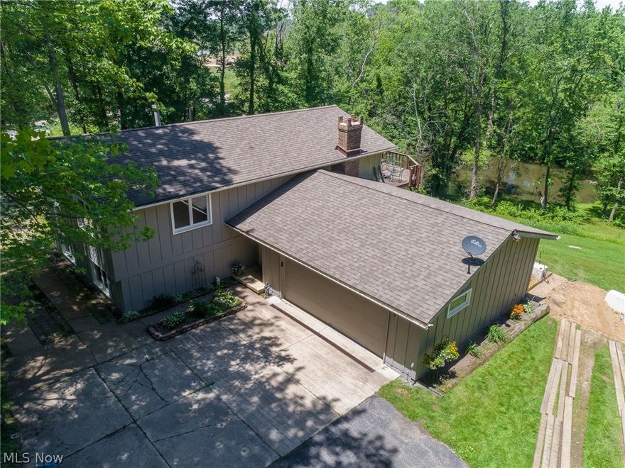 Absolutely stunning!  This bi-level/contemporary designed home sits on a little over 2 acres and has tons of frontage on the Cuyahoga River!  Sitting safely above the river on a hill, the views are absolutely breathtaking!  In the heart of Mantua, nothing to do but move into this 3 bedroom, 2 bath, fully-renovated home!  Open glamour kitchen has been completely remodeled.  There's plenty of room to entertain on the new deck and patio.  Huge outbuilding located near the home has tons of potential for any handyman's needs.  Truly a must-see!  Call today before this one is SOLD!