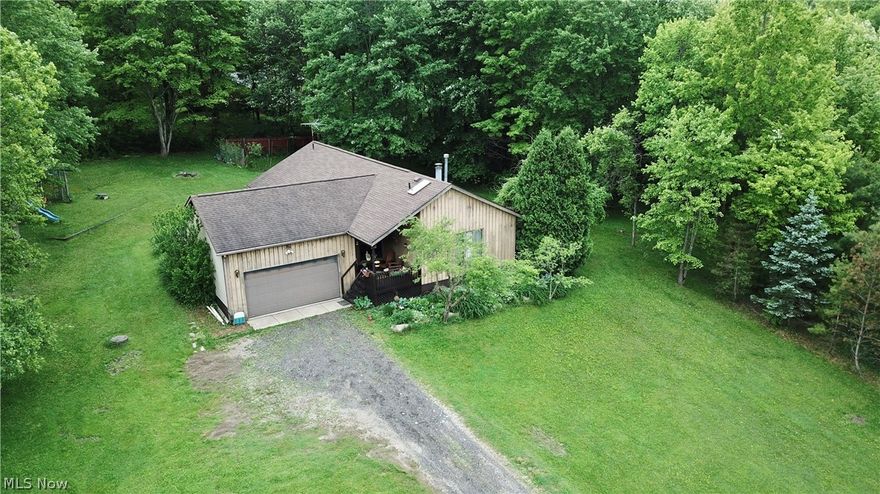 Fantastic one story home on gorgeous 1.19 acre lot in Woodridge School District! Peace and tranquility. Set back from the road on private dead-end street, you will enjoy this lovely park-like yard with beautiful perennial plantings, fruit trees, & flowers: Apple, Peach, Grapes, Wisteria, Hearty Hibiscus, Iris, Daylillies, Hostas, Rose of Sharon, & more. Ample natural light streams through the skylights & large windows in the vaulted ceiling of the Living Room with charming wood mantle & cozy gas fireplace. Through the sliding glass door, you'll find the 1st of 3 outdoor decks overlooking the serene yard. The kitchen is open to Living Room & Dining Room. Sliding door from Dining Room leads to 2nd deck flanked by Irises, Daylillies & greenery. The Owner's suite features vaulted ceiling, 3 closets, private en-suite bathroom with updated vanity, and private deck looking out over the Wisteria trellis & grape vines. 2 additional bedrooms & full bath complete the main floor. In the lower leve