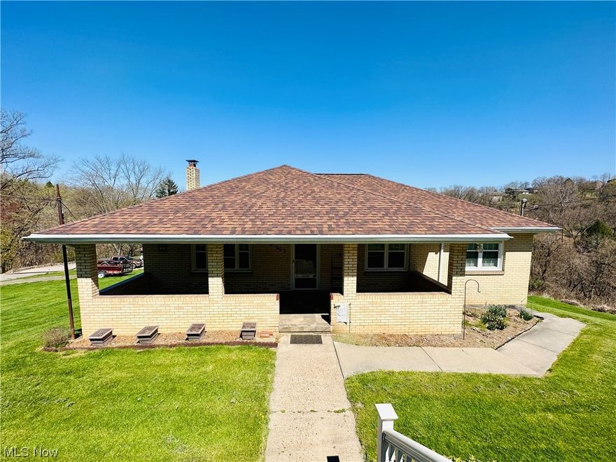 Charming brick home with an abundance of character in convenient location boasting over 3,000 sqft of finished living space. The home welcomes you with a covered and tiled front porch that takes you into a large living room. From there you are taken into a dining room that flows into the large kitchen. Off the kitchen is a heated enclosed sun room that spans almost the whole length of the house with breath taking views of rolling forestry. On the main level there is also three nice sized bedrooms and an updated bath. The lower level is complexly finished basement featuring a second kitchen, bar, rec room, storage, office space, work space, laundry room, and a second updated full bath. Outside features a nice yard with fire pit, newer retaining walls in front yard.