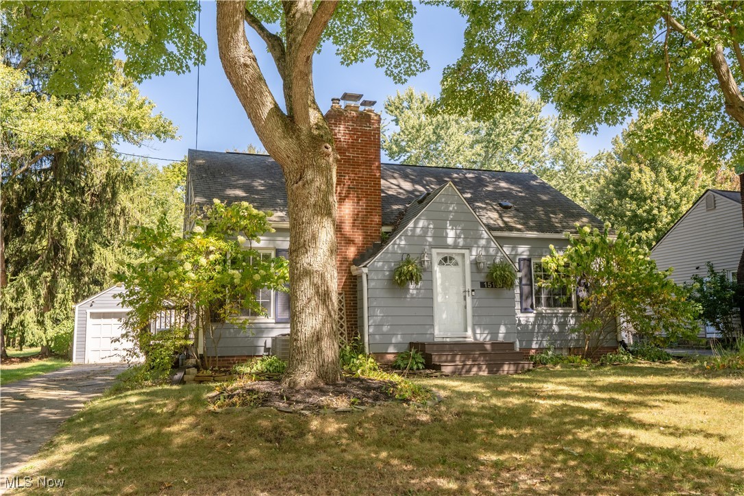 This Cape Cod home built in 1949 offers three bedrooms and two full bathrooms with a detached one-car garage. The main level features a living room with a wood burning fireplace, a full bath, two bedrooms, and a renovated kitchen with white cabinetry, granite countertops, tile backsplash, stainless steel appliances, and a dining area with french doors leading to the deck and fenced backyard.
The upper level has a large third bedroom with new flooring installed in 2023. Additional updates include a new dishwasher in 2025, new living room flooring in 2024, fresh interior paint in 2025, and deck stain in 2025. The property combines classic character with recent updates, providing both charm and functionality.