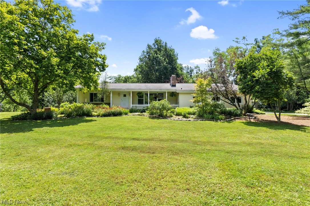 Don't settle for the ordinary. Take a look at this awesome ranch set on 2.5 acres of naturalized gardens, and park like private serenity. City water & sewer convenience! You'll love the open floor plan with the walls of windows to experience nature all year round. Warm up around the gas log fireplace complemented with an antique oak mantle reflecting back the beautiful red oak hardwood floors. A French Country Farmhouse Kitchen includes granite topped custom cabinets, some with leaded glass, an apron front farm sink from France and an antique style stove from Elmira Stove Works w/convection oven. 3 zone heating and cooling. Entertain surrounded by nature in your new outdoor kitchen, complete with a Pizza Oven! Amazing newer Barn 2018 w/running water and a cool she shed attached for No bug dining. A great chicken house any chicken or rooster would be proud to call home. In back of the barn lies your own potting patio. Grow your own fruits and veggies in your fenced gardens. Seller has i