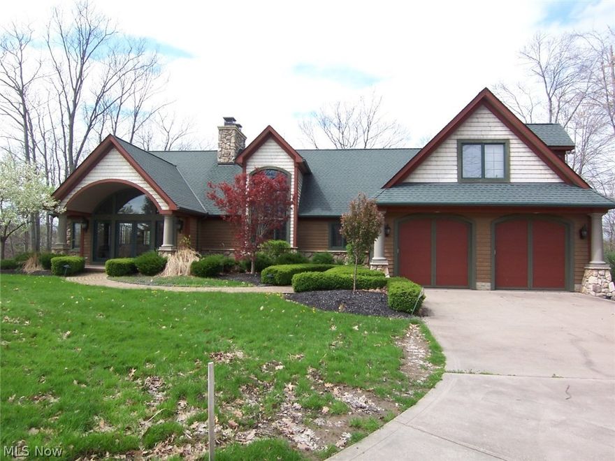 THE premier property in Roaming Shores! This property is the "Top of the Shores". A 2.6 acre peninsula surrounded by water with nearly a mile lake view both to the north and the south. Wonderful cement drive to house and boat house. 28X25 log cabin boat house with an additional 15x12 storage room with vaulted wood and log walls and ceiling. Boat house is in it's own cove on one corner of the property keeping all your water toys safe and secure. Home is a wonderful timber frame construction with kitchen, great room, and dining rooms in an open plan other than the see through 17 foot tall stone fireplace separating kitchen from great room, and all with wood beamed and vaulted ceilings. Kitchen with walnut cabinets, granite tops and island with breakfast bar and extra prep sink. An additional circular breakfast nook with granite table to match kitchen's tops, make the whole family space perfect. First floor master suite has sitting room with gas FP and 9' doors to both west and north faci