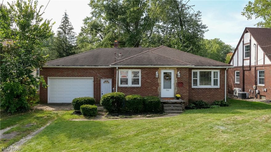 Wonderful opportunity to own a charming brick ranch in the quiet Tappan neighborhood of eastern Ravenna. This home will delight you with a cheerful, fully applianced eat-in kitchen, perfect for entertaining. Updated vinyl windows let in the sunshine and plenty of cabinet storage and countertop prep area create a space you'll love making memories in. The living room features durable hardwood floors, period cove ceilings, and charming original wood trim throughout.  Three bedrooms provide plenty of room for all, with closet space galore! Updated paint, tile flooring and vanity in the bathroom feel at once cozy and spa-like.  The waterproofed lower level full basement offers a world of possibility - bring your imagination and finishing touches to make it your own. You'll appreciate the attached 20 x 26 two car garage with two pass-through garage doors, plus two driveways for extra convenience - one on East Main and one on the south side of the home on East Maple Lane.  This home offers a
